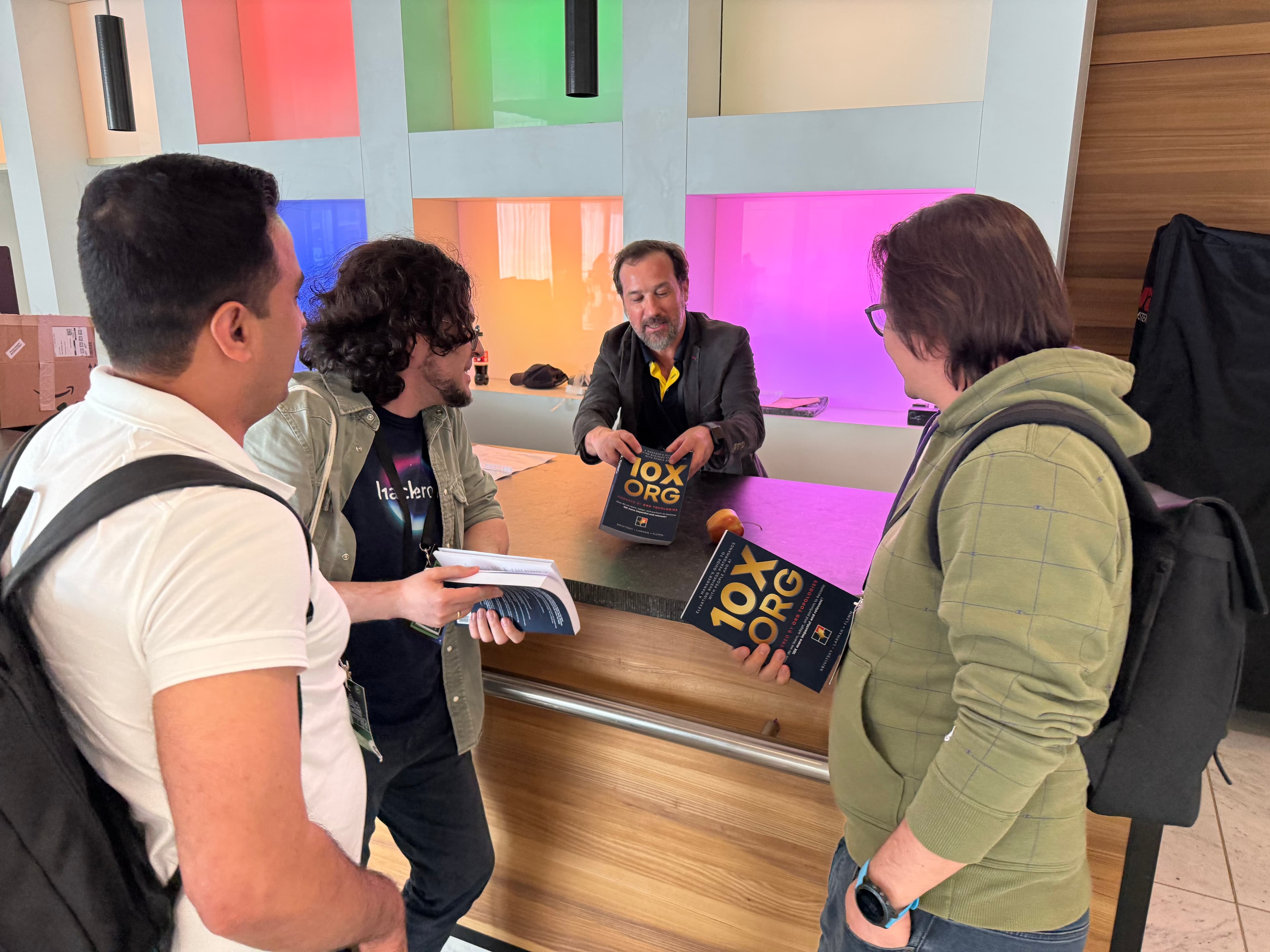 Alexey signing 10X ORG books at a conference