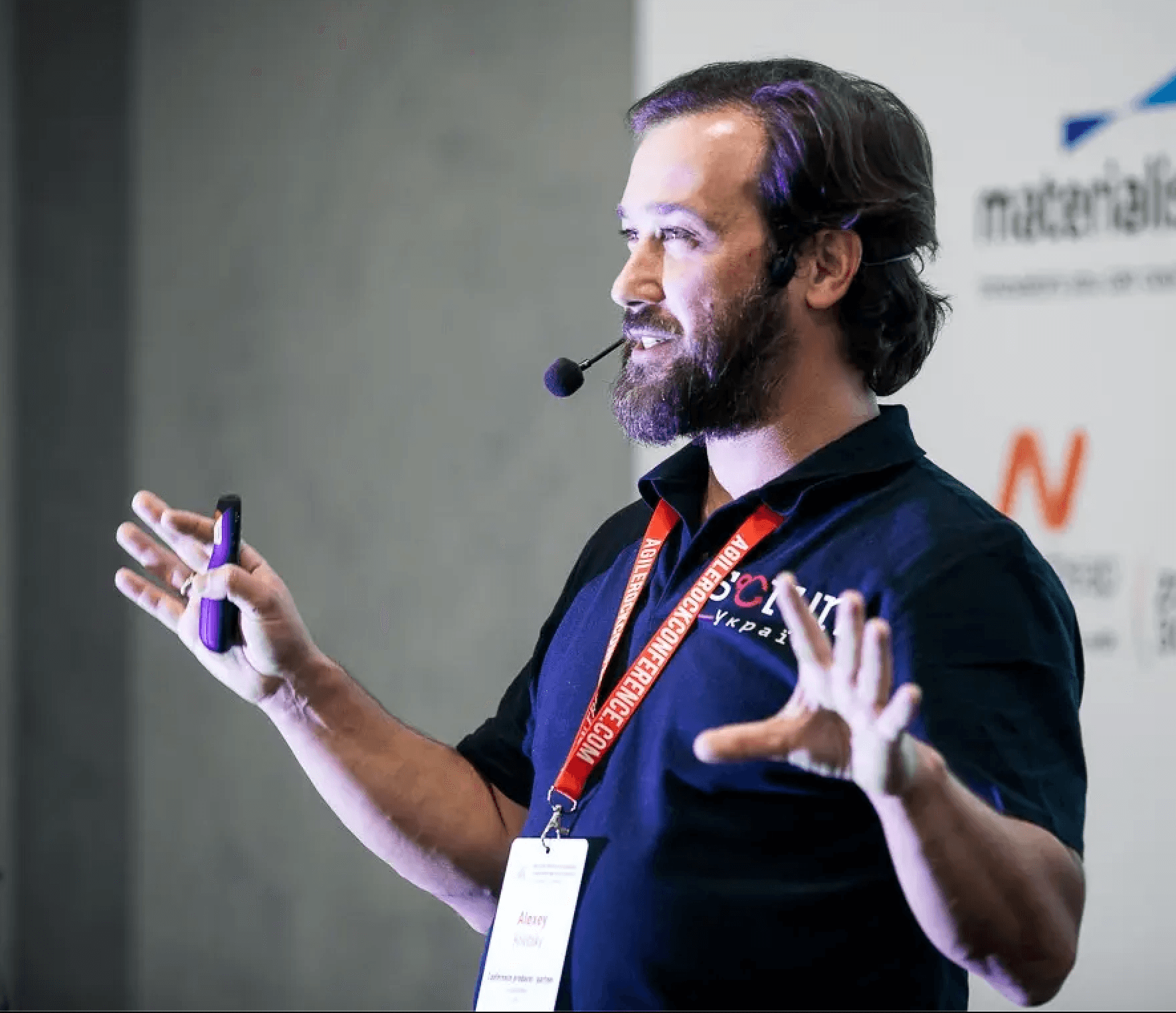 Alexey Krivitsky — AI and Org Design consultant Alexey Krivitsky, AI and Org Design consultant, speaking on stage with a headset microphone