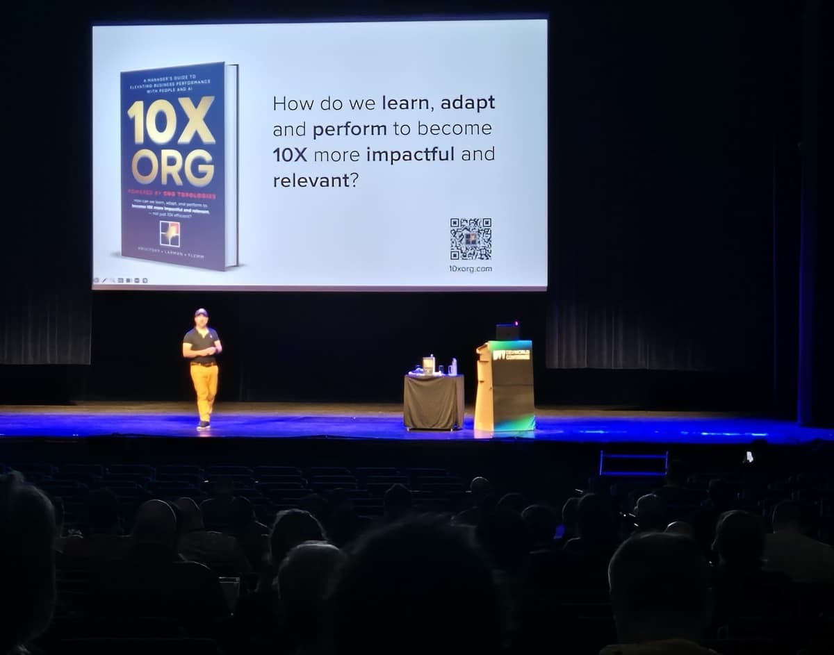 Alexey presenting 10X ORG on a large conference stage