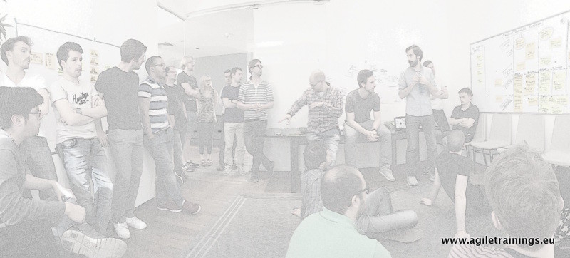 Multi-team Scrum workshop room — large group around a shared product board