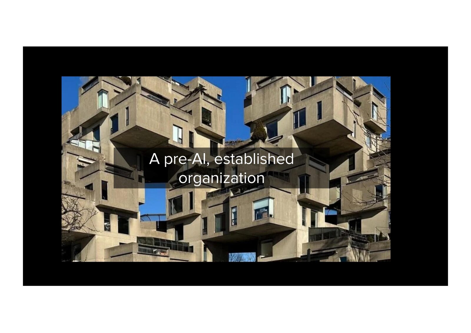 A pre-AI, established organization — a dense modular concrete building.